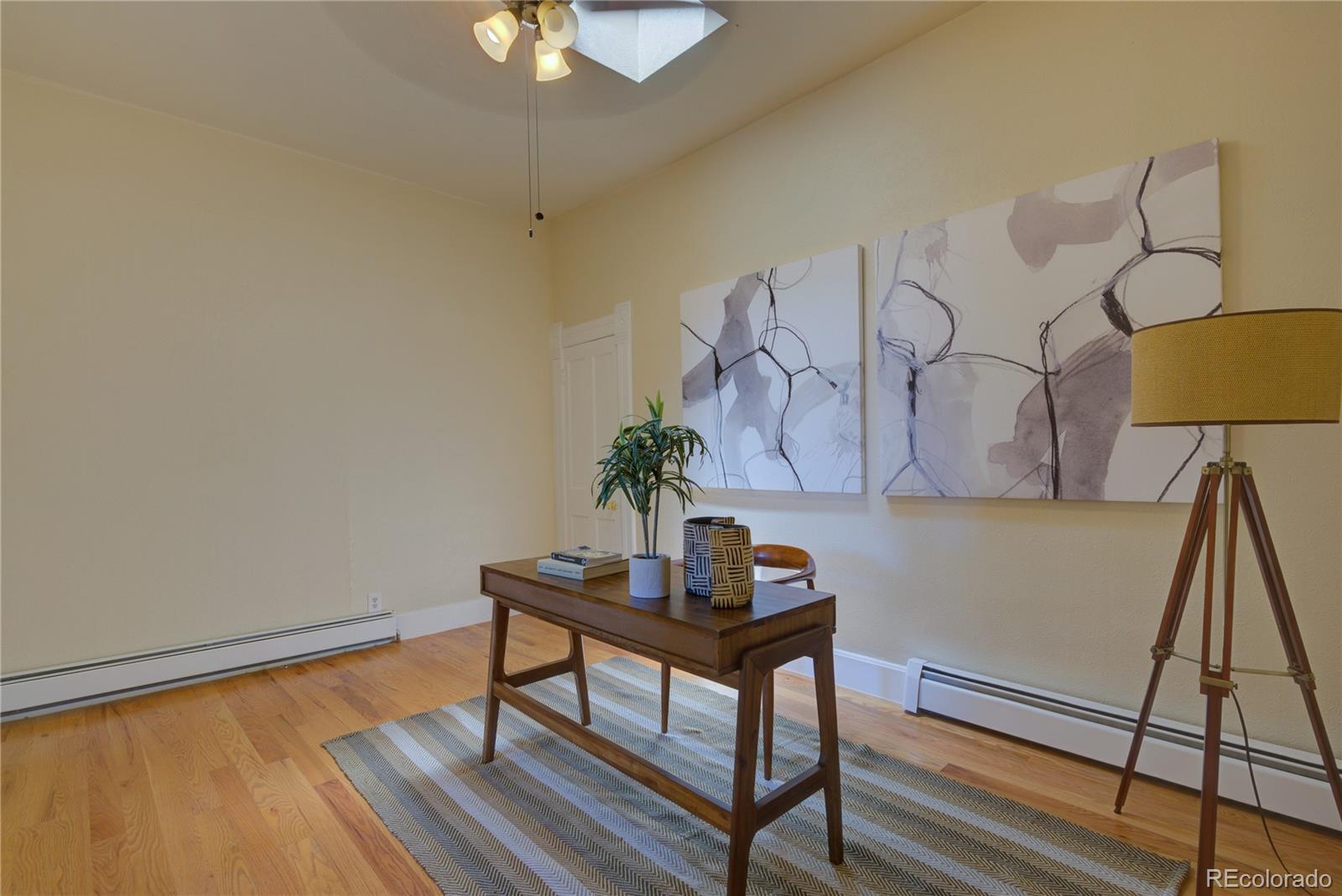 2537 Ames Street Edgewater, CO 80214 - Photo 9 of 38 a view of a workspace with furniture and a potted plant
