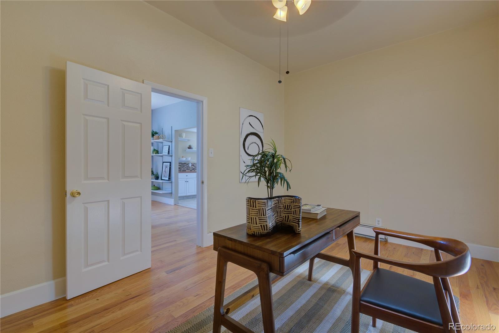 2537 Ames Street Edgewater, CO 80214 - Photo 10 of 38 a view of a workspace with furniture and wooden floor