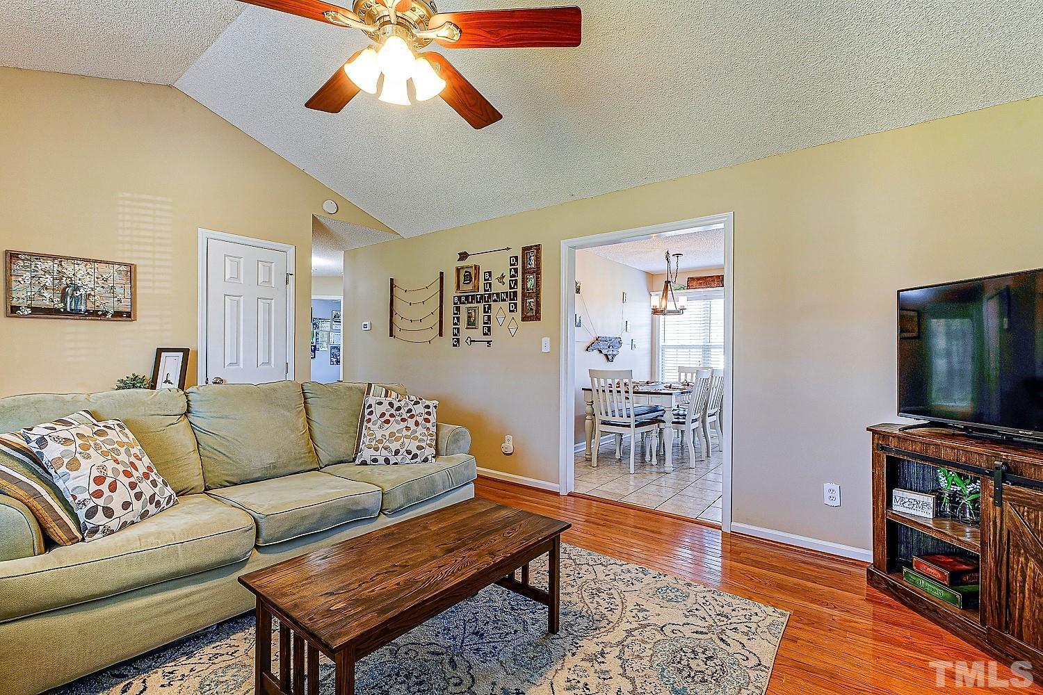 1001 Retriever Lane Raleigh, NC 27603 - Photo 16 of 50 a living room with furniture and a flat screen tv