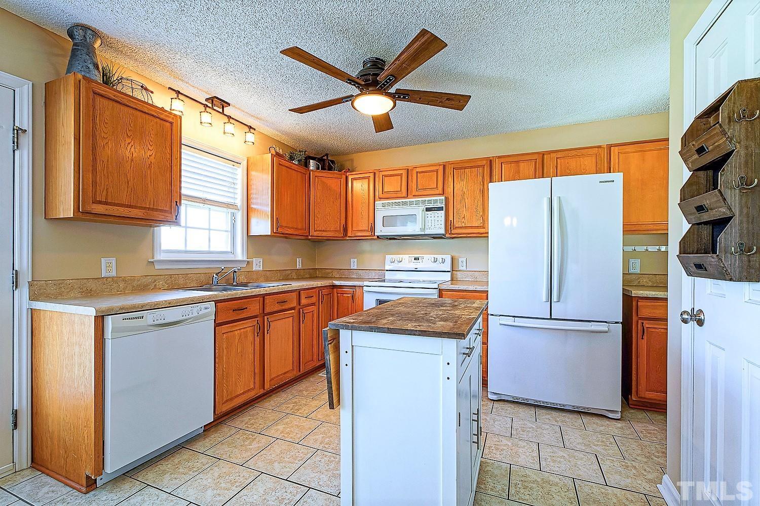 1001 Retriever Lane Raleigh, NC 27603 - Photo 20 of 50 a kitchen with stainless steel appliances granite countertop a refrigerator and a sink