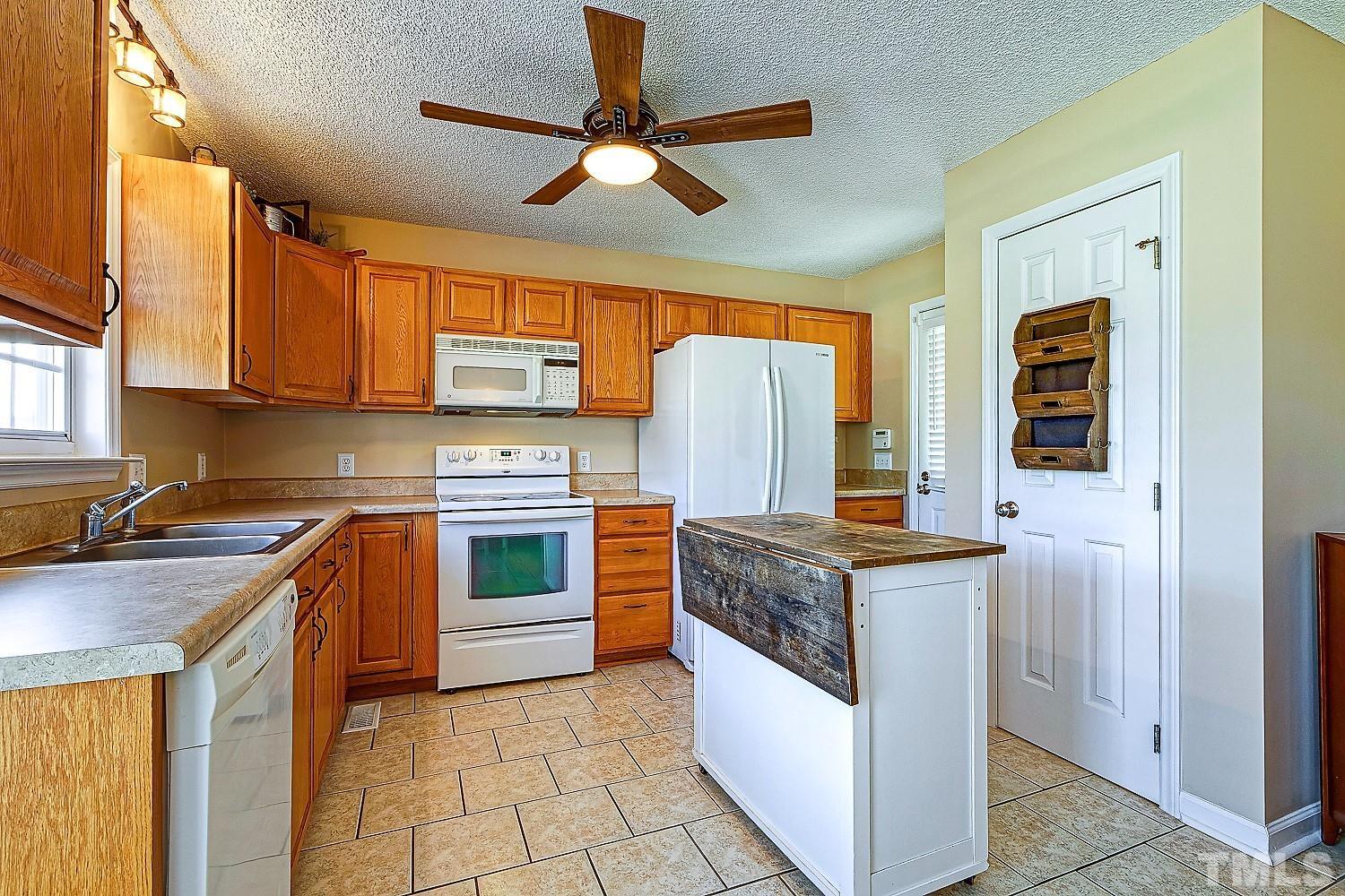 1001 Retriever Lane Raleigh, NC 27603 - Photo 22 of 50 a kitchen with stainless steel appliances granite countertop a stove a refrigerator and a sink