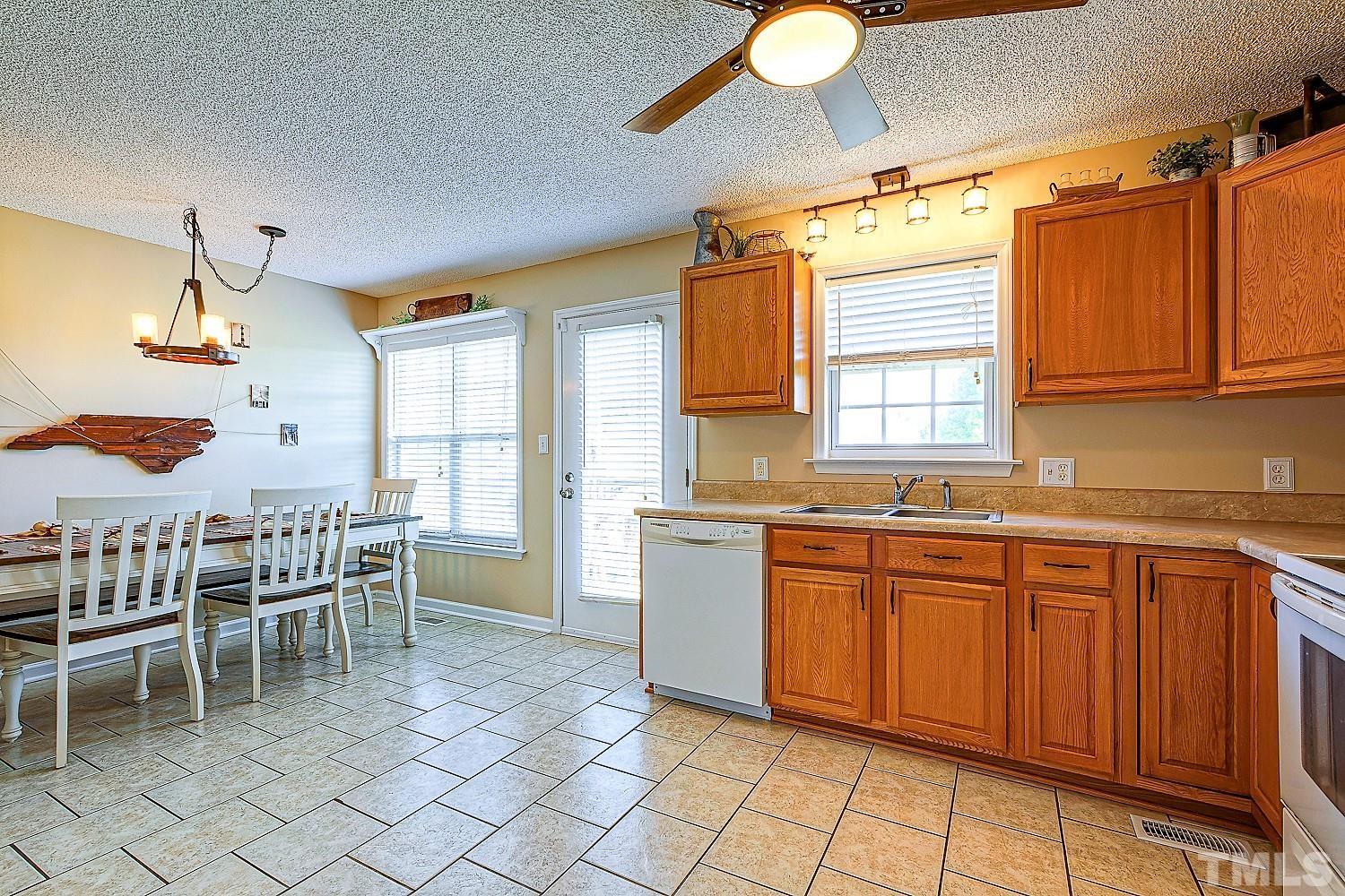 1001 Retriever Lane Raleigh, NC 27603 - Photo 24 of 50 a kitchen with a sink and chairs