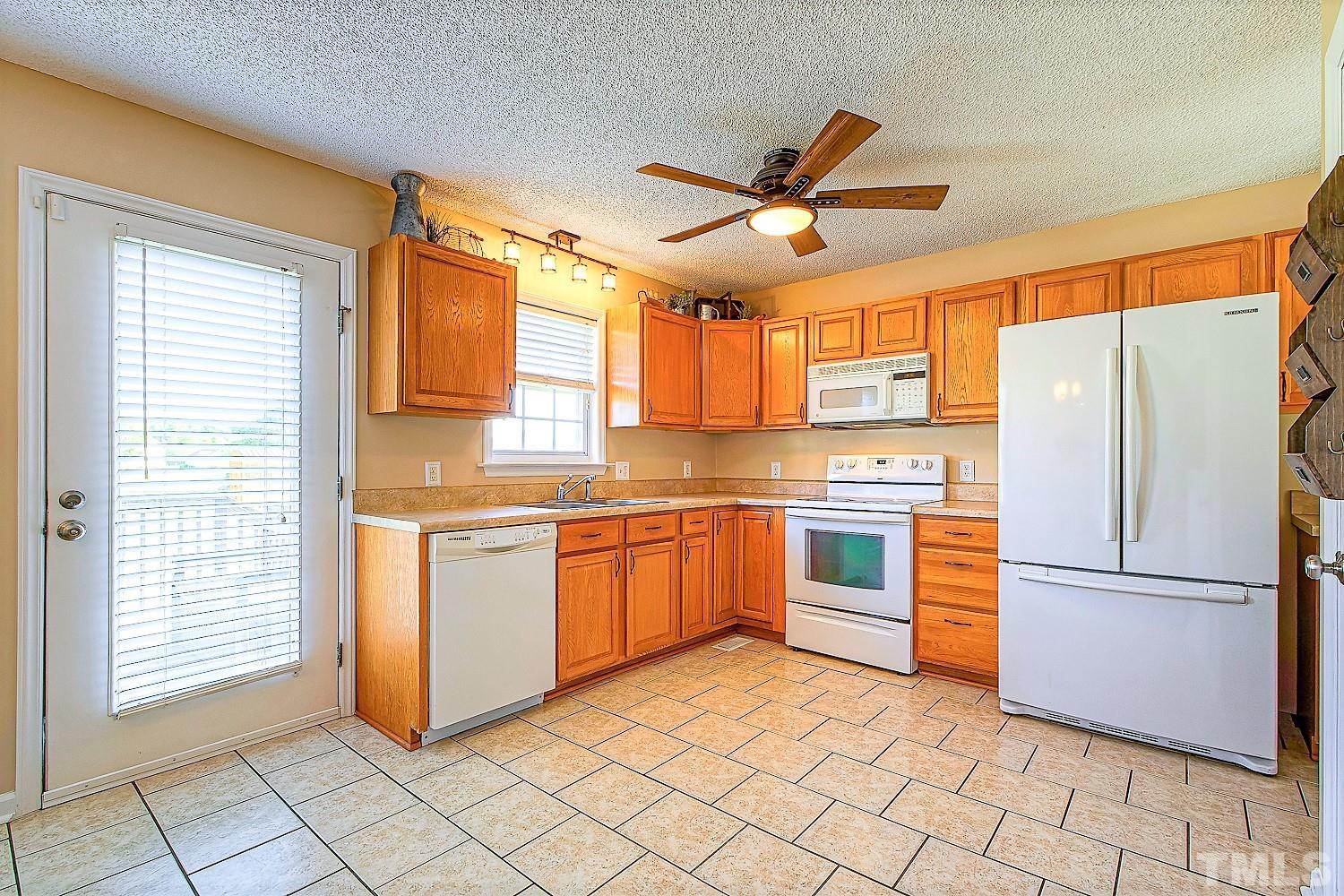 1001 Retriever Lane Raleigh, NC 27603 - Photo 25 of 50 a kitchen with stainless steel appliances granite countertop a refrigerator and a sink
