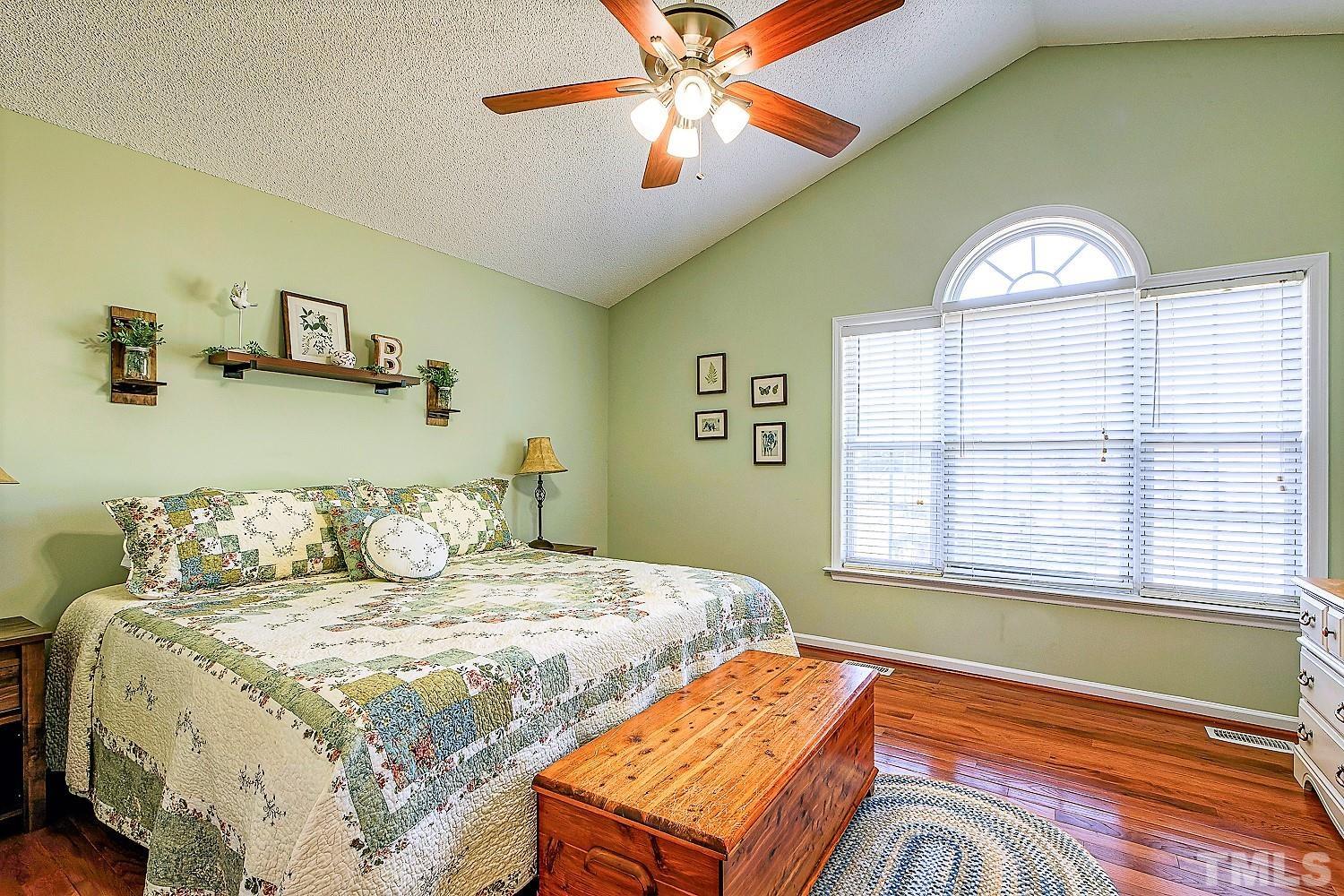 1001 Retriever Lane Raleigh, NC 27603 - Photo 26 of 50 a bedroom with a bed and a chandelier