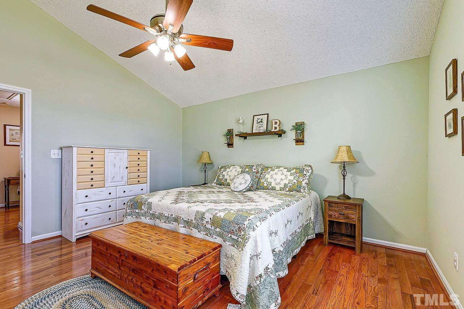 1001 Retriever Lane Raleigh, NC 27603 - Photo 27 of 50 a bedroom with a bed and a chandelier