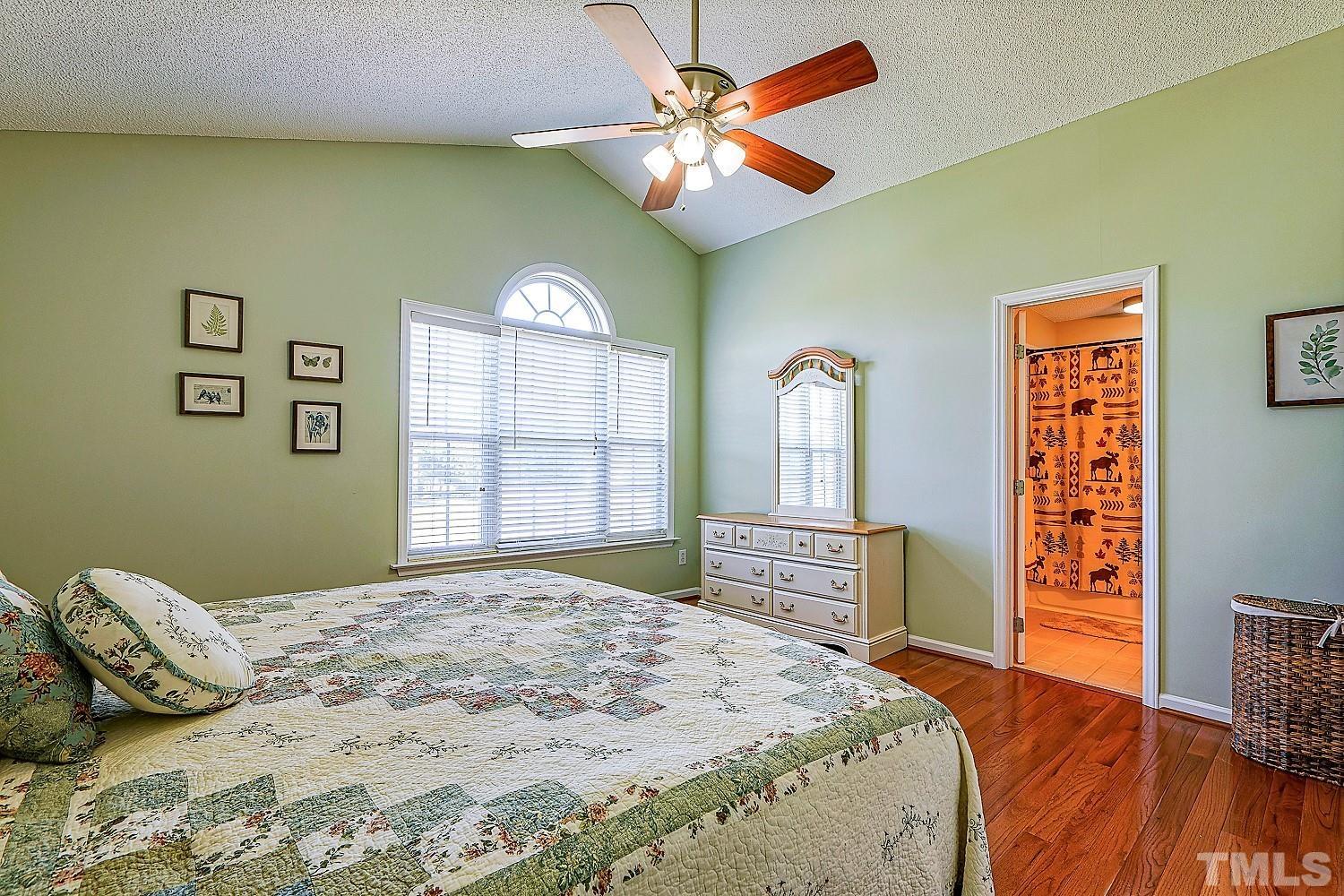 1001 Retriever Lane Raleigh, NC 27603 - Photo 29 of 50 a bedroom with a bed and a dresser with mirror