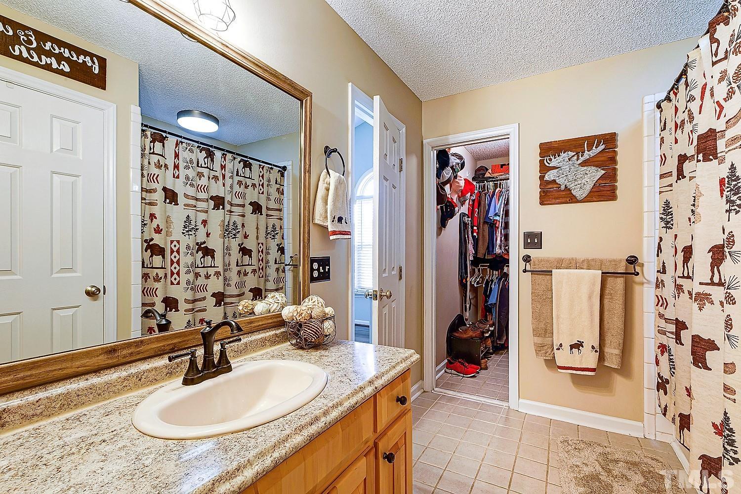 1001 Retriever Lane Raleigh, NC 27603 - Photo 32 of 50 a bathroom with a sink double vanity and shower