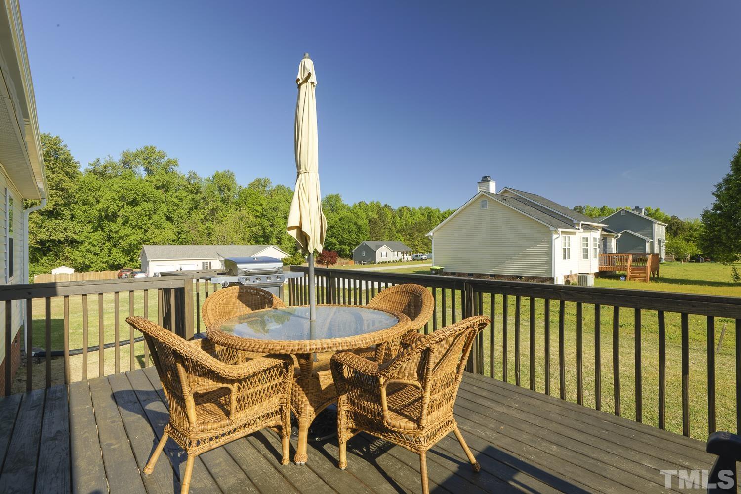 1001 Retriever Lane Raleigh, NC 27603 - Photo 39 of 50 a view of a balcony with furniture and wooden deck