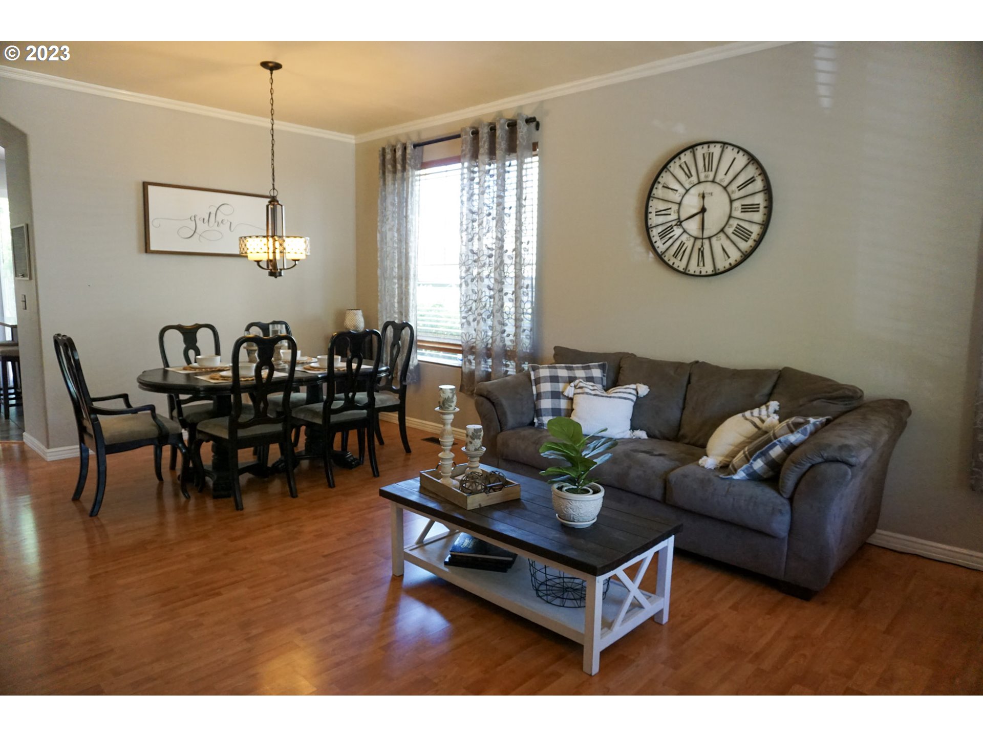 1864 Heitzman Way Eugene, OR 97402 - Photo 11 of 26 a living room with furniture a clock on wall and a window