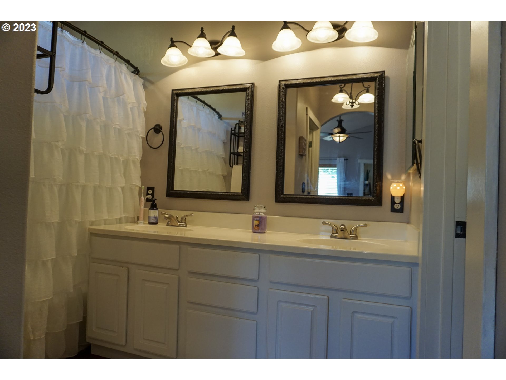 1864 Heitzman Way Eugene, OR 97402 - Photo 14 of 26 a bathroom with a double vanity sink and a mirror