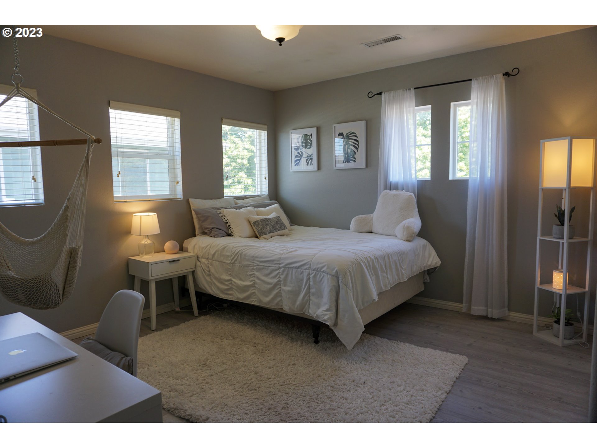 1864 Heitzman Way Eugene, OR 97402 - Photo 16 of 26 a bedroom with a bed wooden floor and windows
