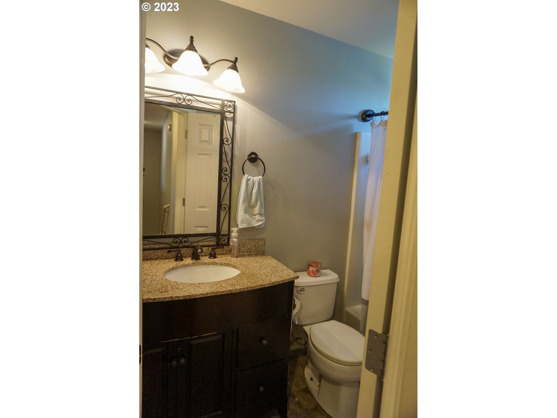 1864 Heitzman Way Eugene, OR 97402 - Photo 18 of 26 a bathroom with a granite countertop toilet sink and mirror