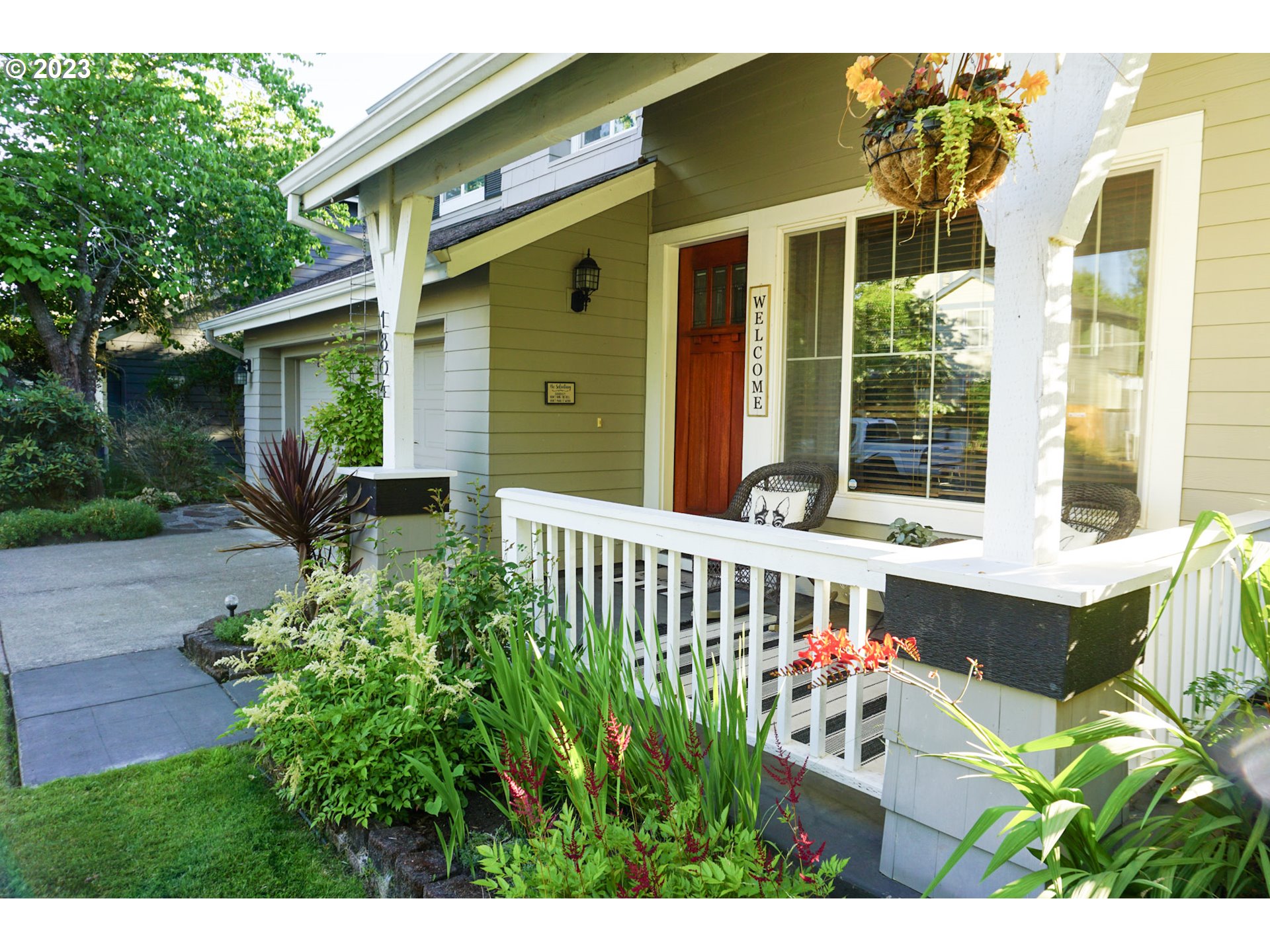 1864 Heitzman Way Eugene, OR 97402 - Photo 3 of 26 a front view of a house with a garden