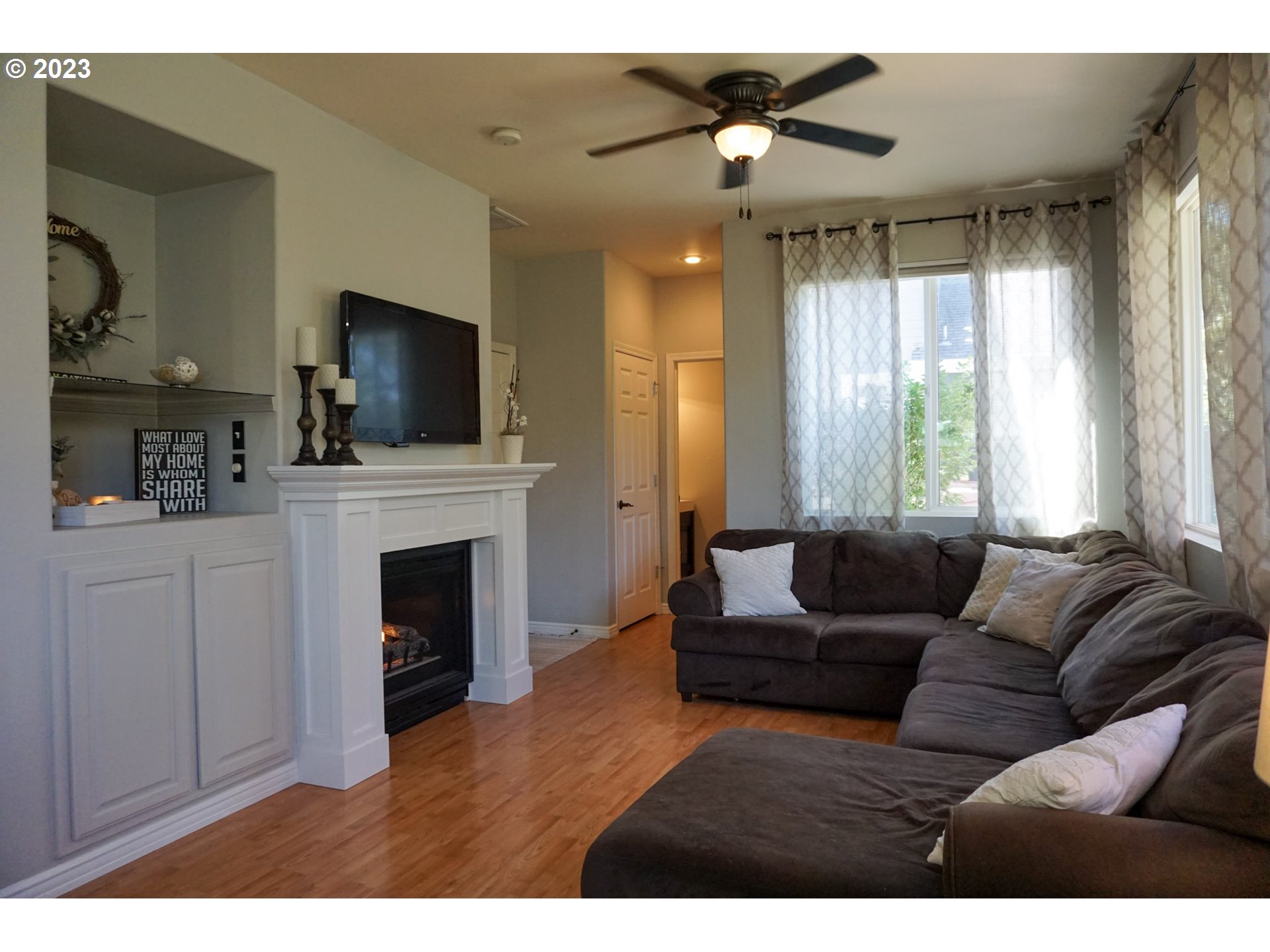 1864 Heitzman Way Eugene, OR 97402 - Photo 5 of 26 a living room with furniture a fireplace and a flat screen tv