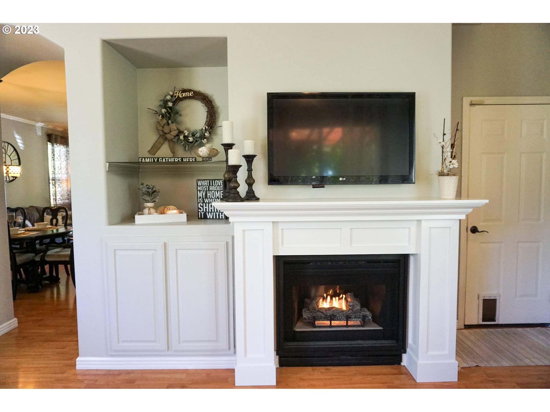 1864 Heitzman Way Eugene, OR 97402 - Photo 6 of 26 a living room with a fireplace a flat screen tv and a fireplace