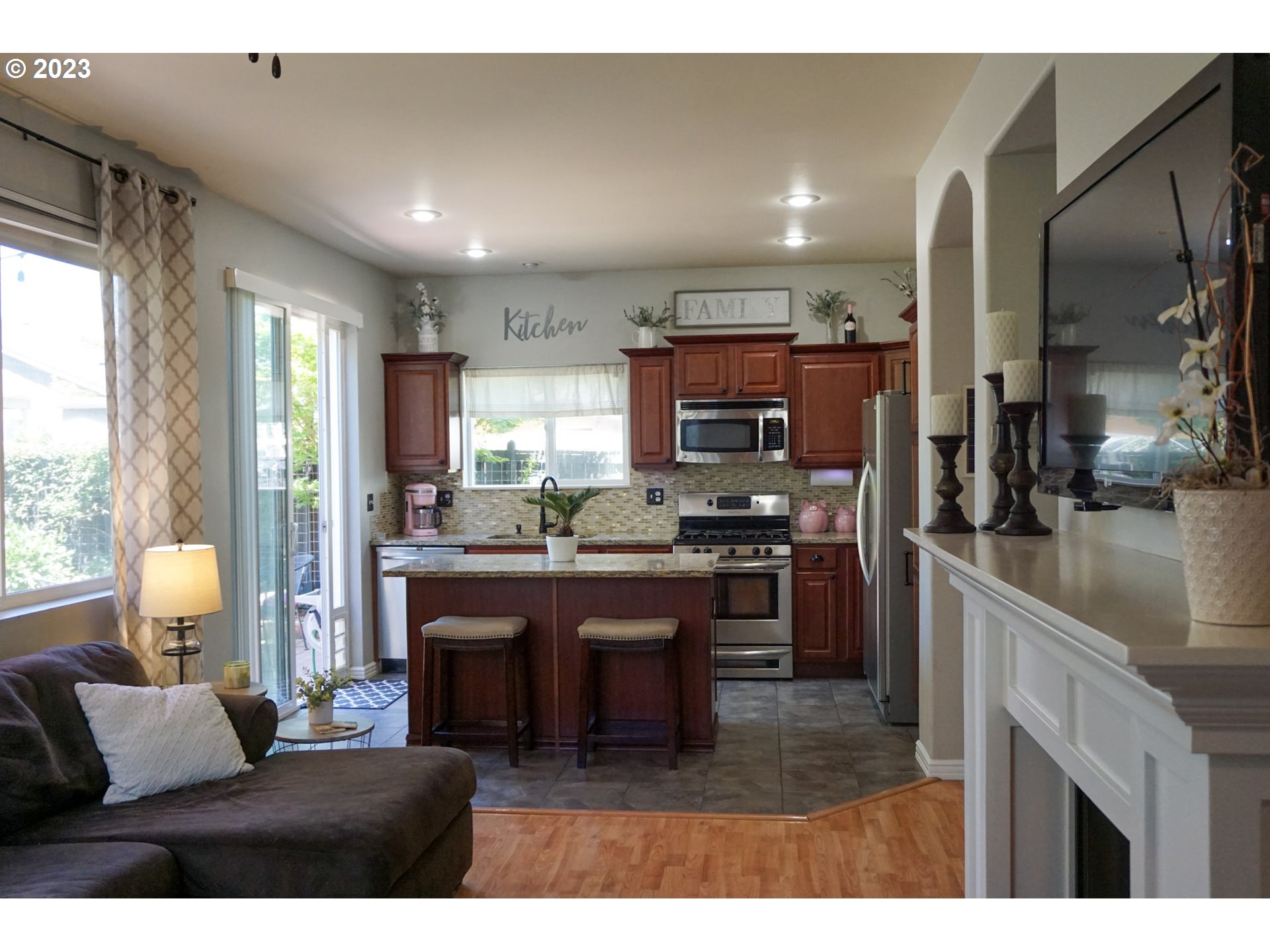 1864 Heitzman Way Eugene, OR 97402 - Photo 7 of 26 a open kitchen with kitchen island granite countertop a refrigerator stove top oven and sink