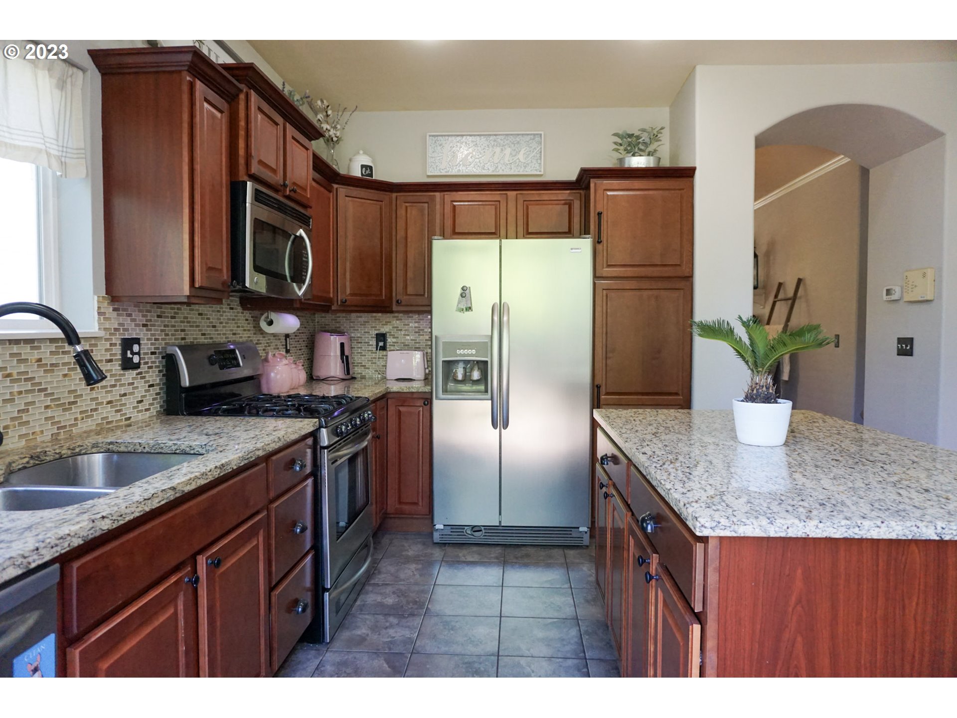1864 Heitzman Way Eugene, OR 97402 - Photo 9 of 26 a kitchen with stainless steel appliances granite countertop a refrigerator a stove a sink and dishwasher