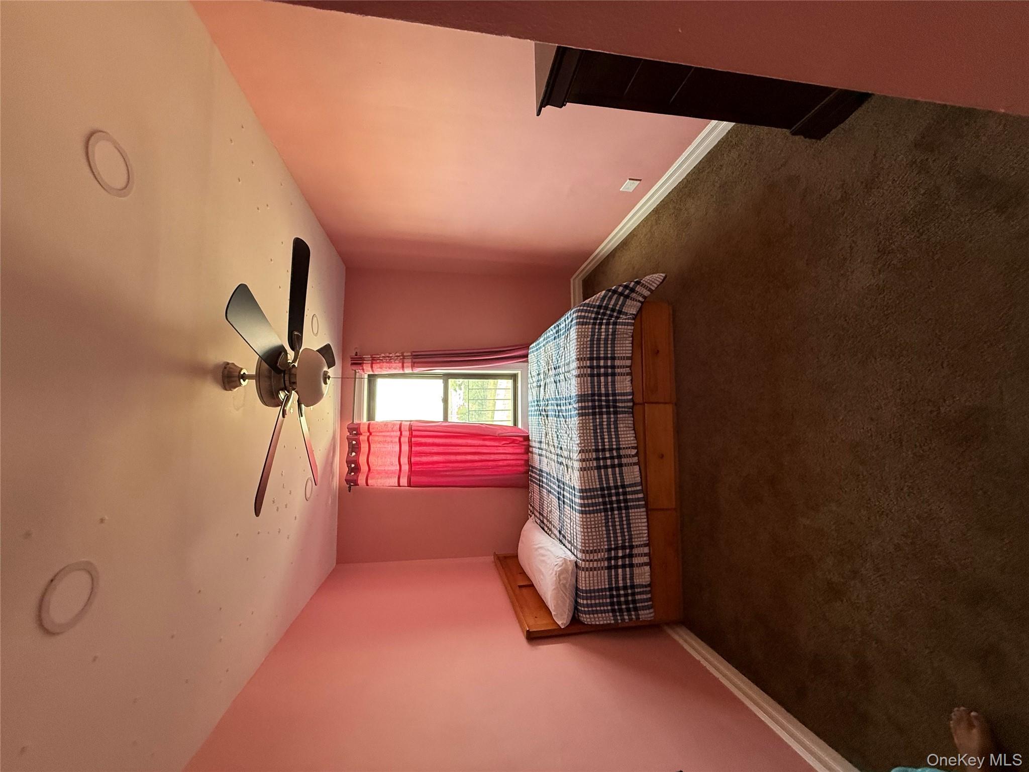 112-30 Northern Boulevard, Unit 4G Queens, NY 11368 - Photo 13 of 18 a room with a bed and a chandelier