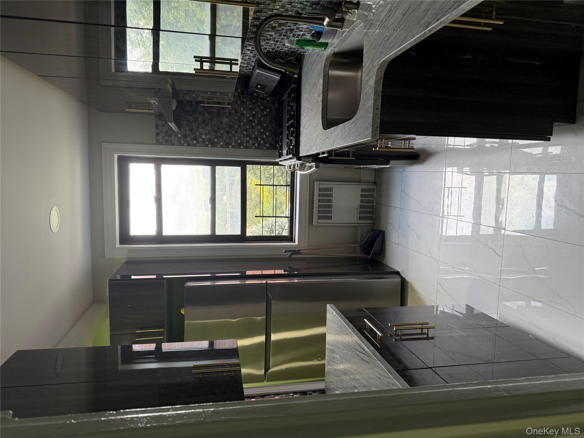 112-30 Northern Boulevard, Unit 4G Queens, NY 11368 - Photo 2 of 18 a kitchen that has a sink a refrigerator and window