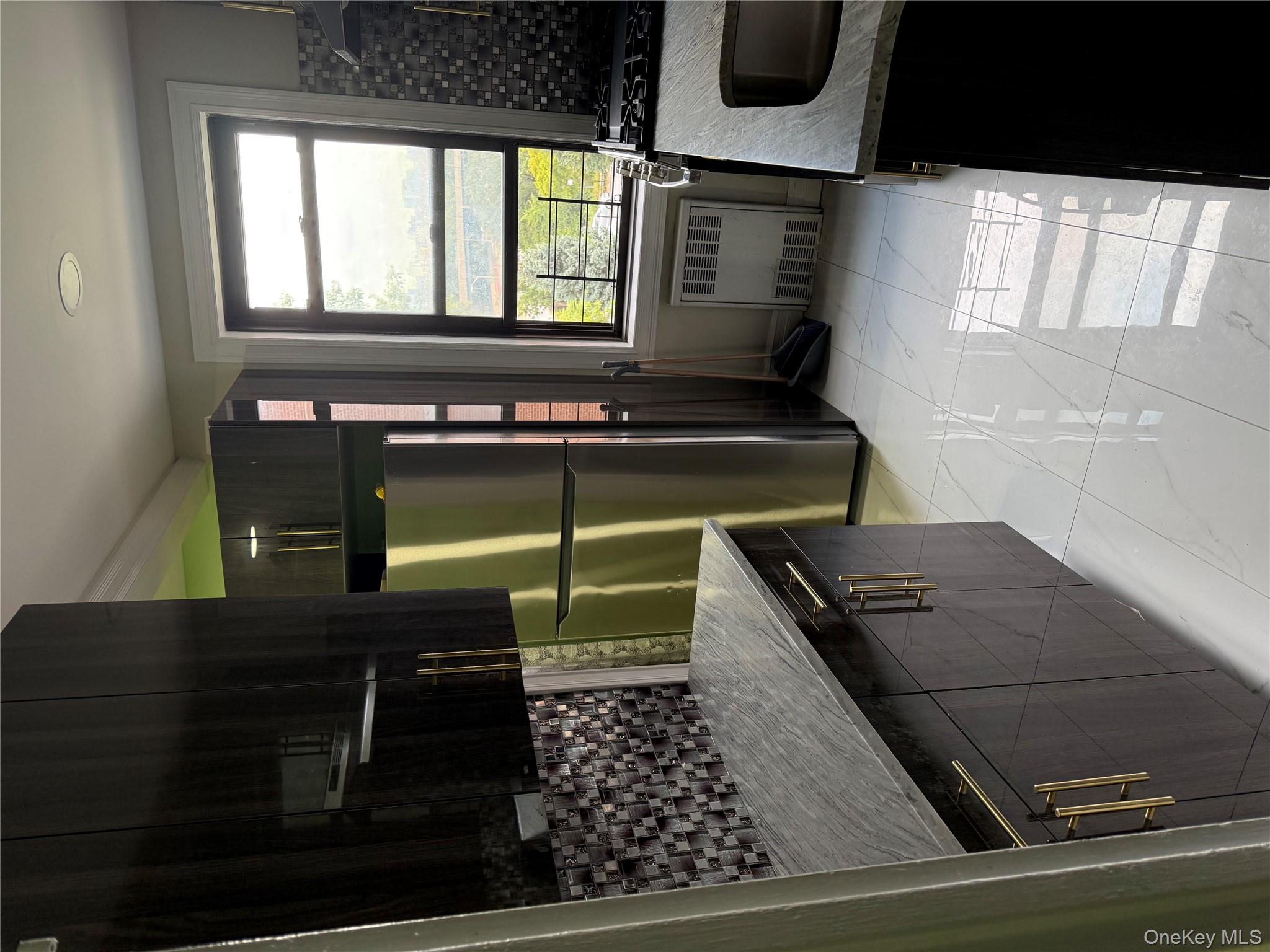 112-30 Northern Boulevard, Unit 4G Queens, NY 11368 - Photo 3 of 18 a kitchen with granite countertop a refrigerator a stove and a sink