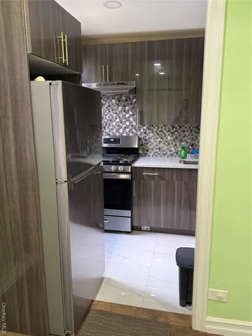 a kitchen with stainless steel appliances granite countertop a refrigerator and a stove