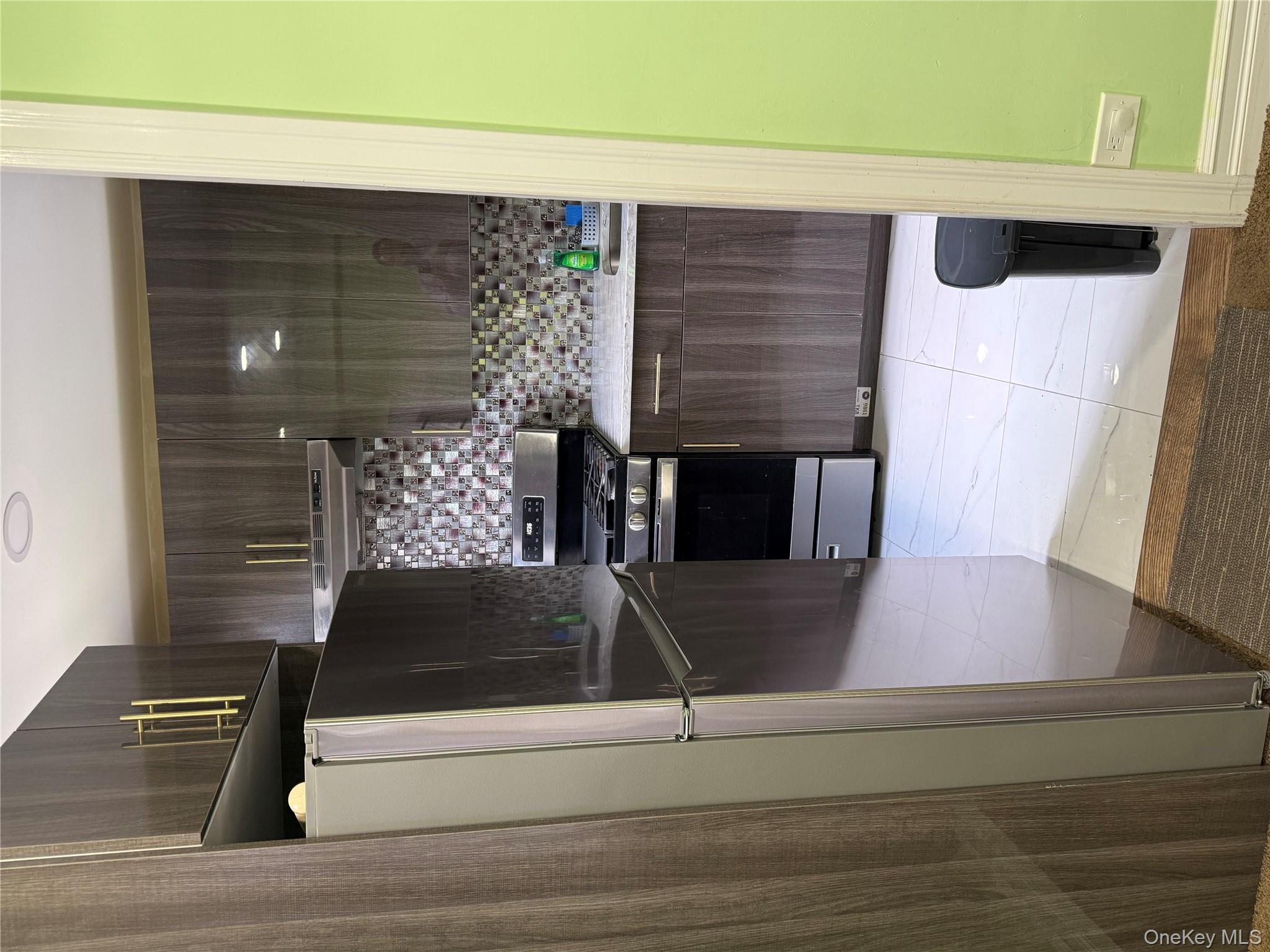 112-30 Northern Boulevard, Unit 4G Queens, NY 11368 - Photo 6 of 18 a kitchen with stainless steel appliances granite countertop a refrigerator and a stove