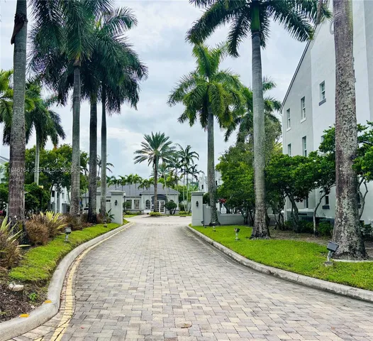 a view of a park with a palm trees