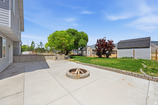 3732 Campbell Road Tooele, UT 84074 - Photo 42 of 69 Expansive concrete patio featuring a built-in stone fire pit