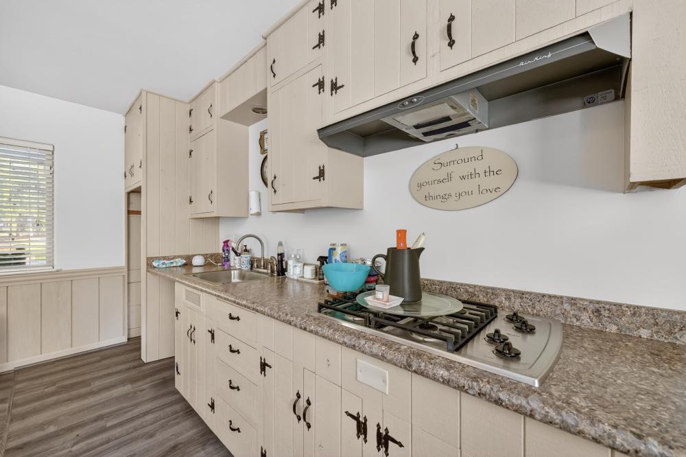 2026 Lily Valley Way West Point, CA 95255 - Photo 34 of 39 a kitchen with cabinets and wooden floor