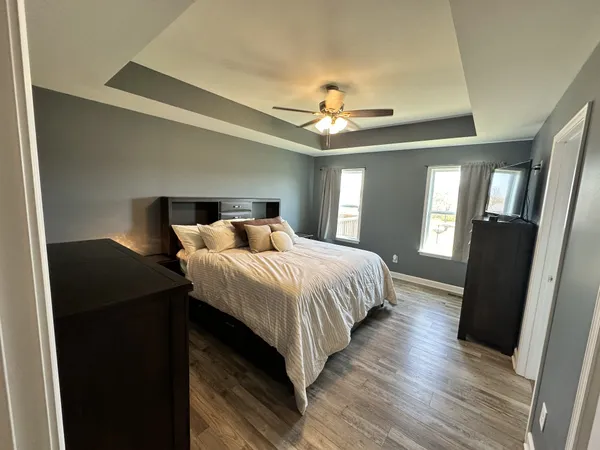 a bedroom with a bed and a flat screen tv