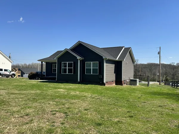 a front view of a house with a yard