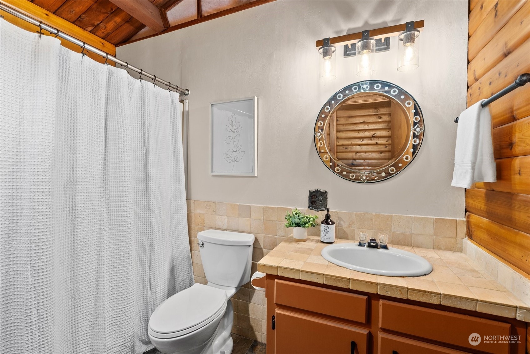 1028 King Road Winlock, WA 98596 - Photo 23 of 38 a bathroom with a sink a mirror a toilet and a window