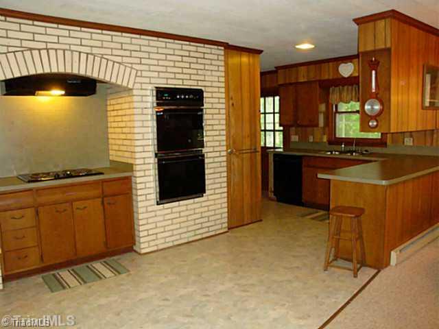 1840 Tussey Road Lexington, NC 27295 - Photo 4 of 16 Kitchen. Large open kitchen with decorative stove/oven area, new counter tops in kitchen, new flooring, all appliances remain including double oven, stove, dishwasher, and refrigerator too