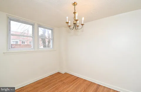 a view of a room with wooden floor and windows