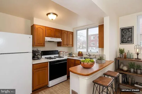 a kitchen with a sink stove and refrigerator