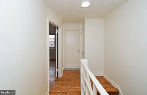 a view of hallway with wooden floor