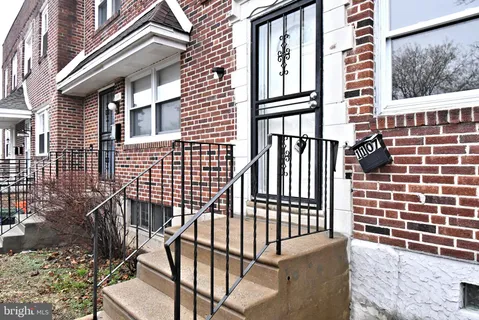 a view of a brick house with many windows
