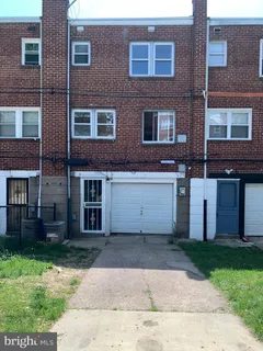 a view of a brick building next to a yard