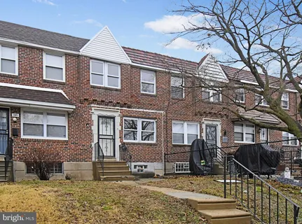 a front view of a house with parking space