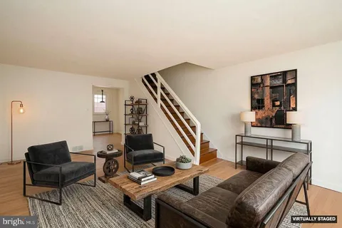 a living room with furniture and a piano