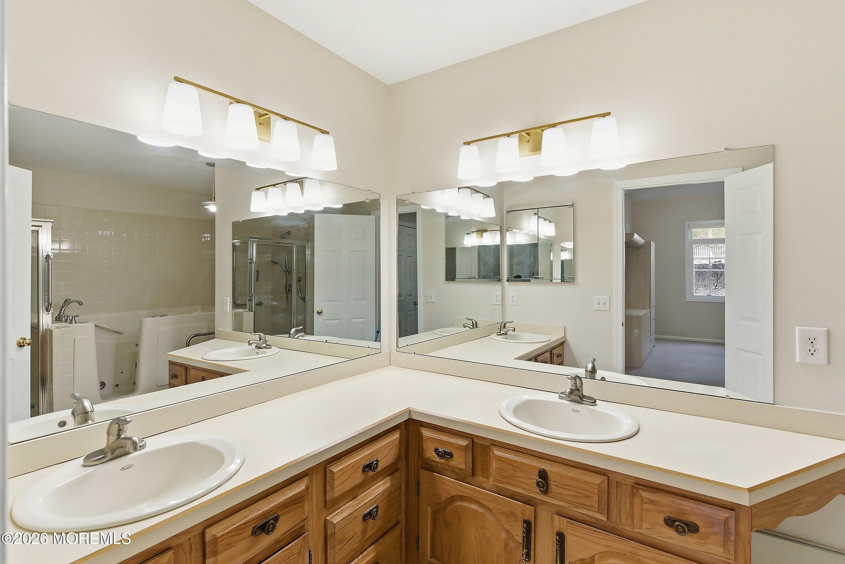 34 B Rutland Lane Monroe Township, NJ 08831 - Photo 17 of 46 a bathroom with a sink double vanity and a mirror