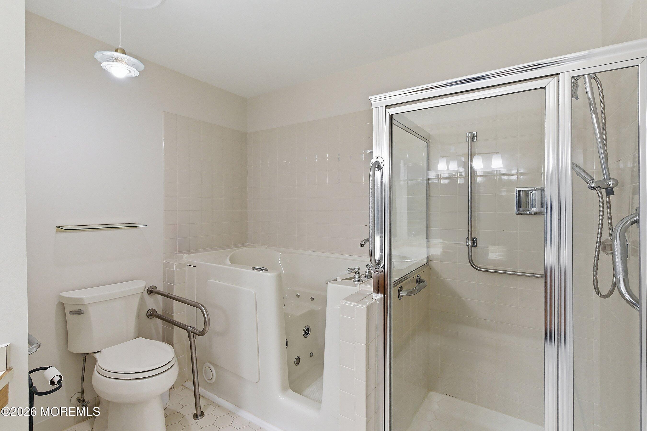 34 B Rutland Lane Monroe Township, NJ 08831 - Photo 18 of 46 a bathroom with a granite countertop toilet and a shower