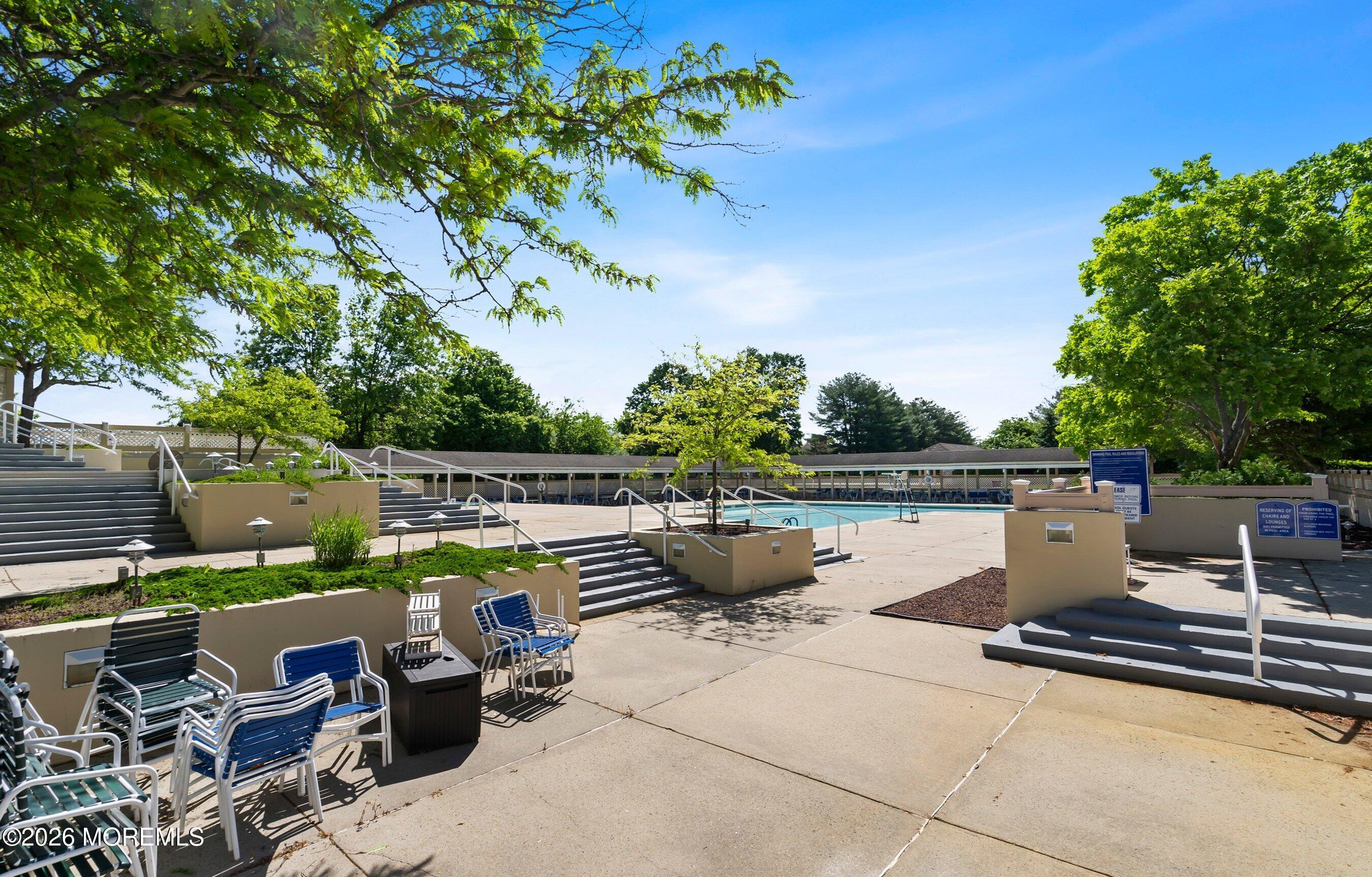 34 B Rutland Lane Monroe Township, NJ 08831 - Photo 37 of 46 a view of a terrace with a bench