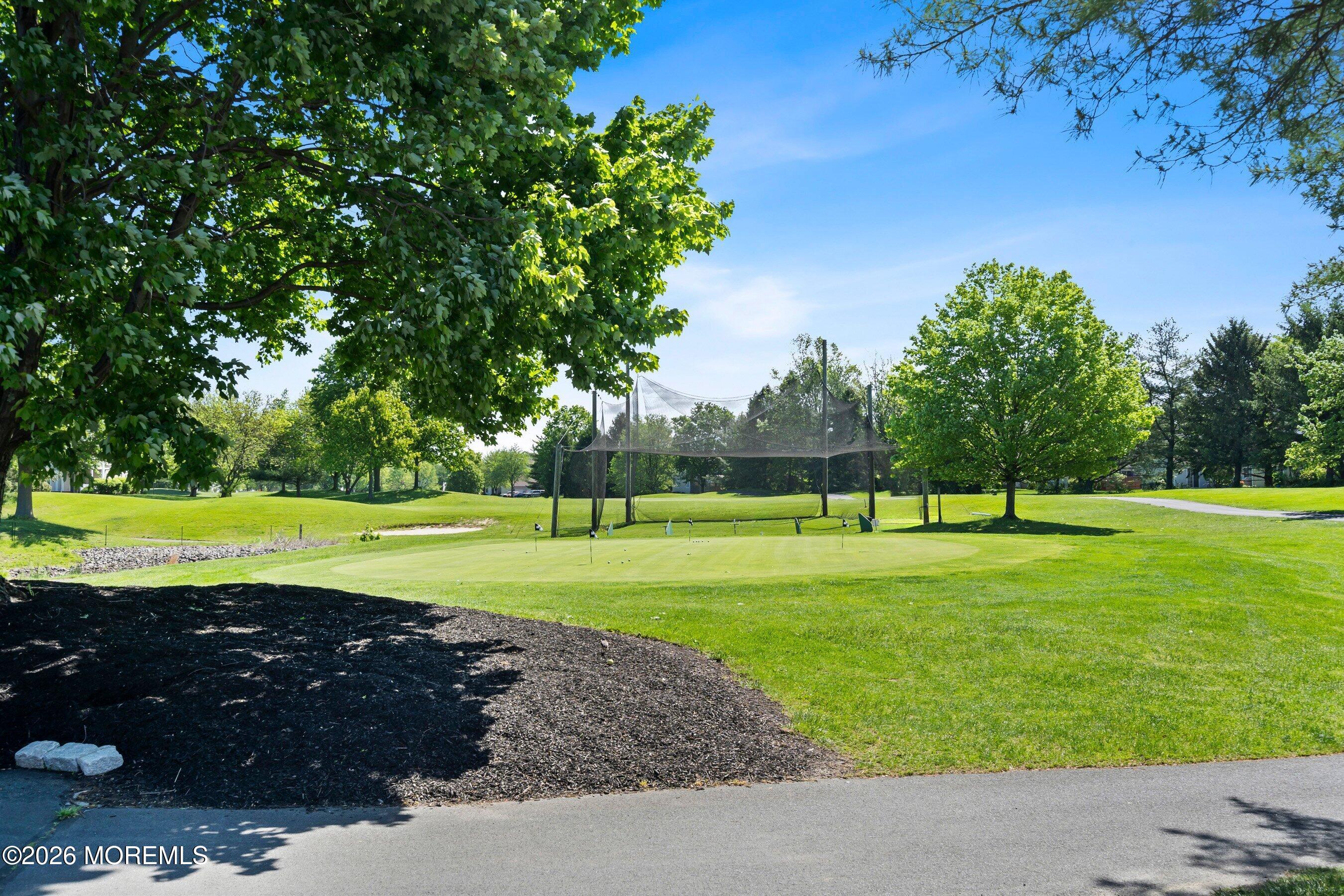 34 B Rutland Lane Monroe Township, NJ 08831 - Photo 39 of 46 a view of a golf course with a lake