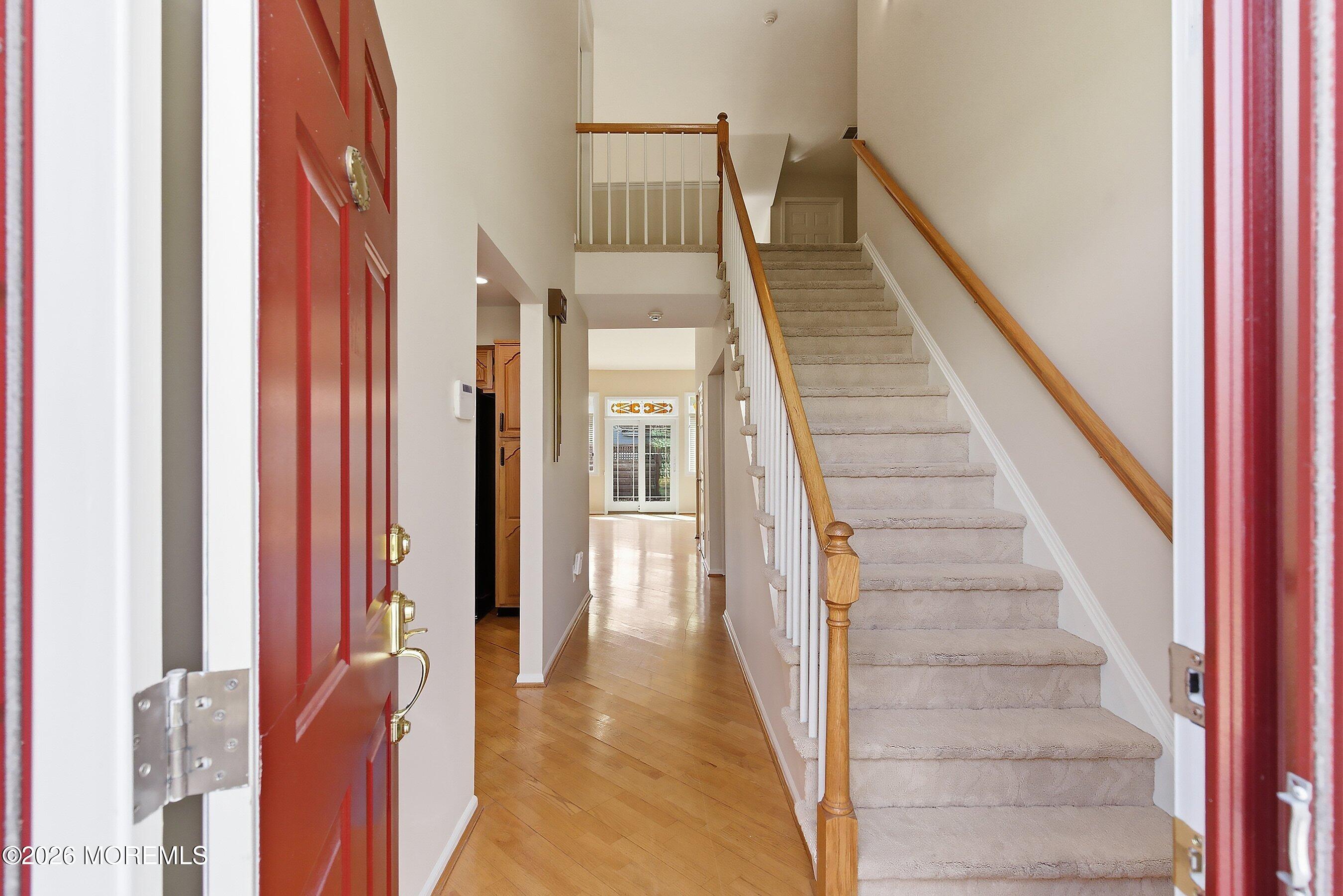 34 B Rutland Lane Monroe Township, NJ 08831 - Photo 4 of 46 a view of staircase with lots of frames on wall and a window