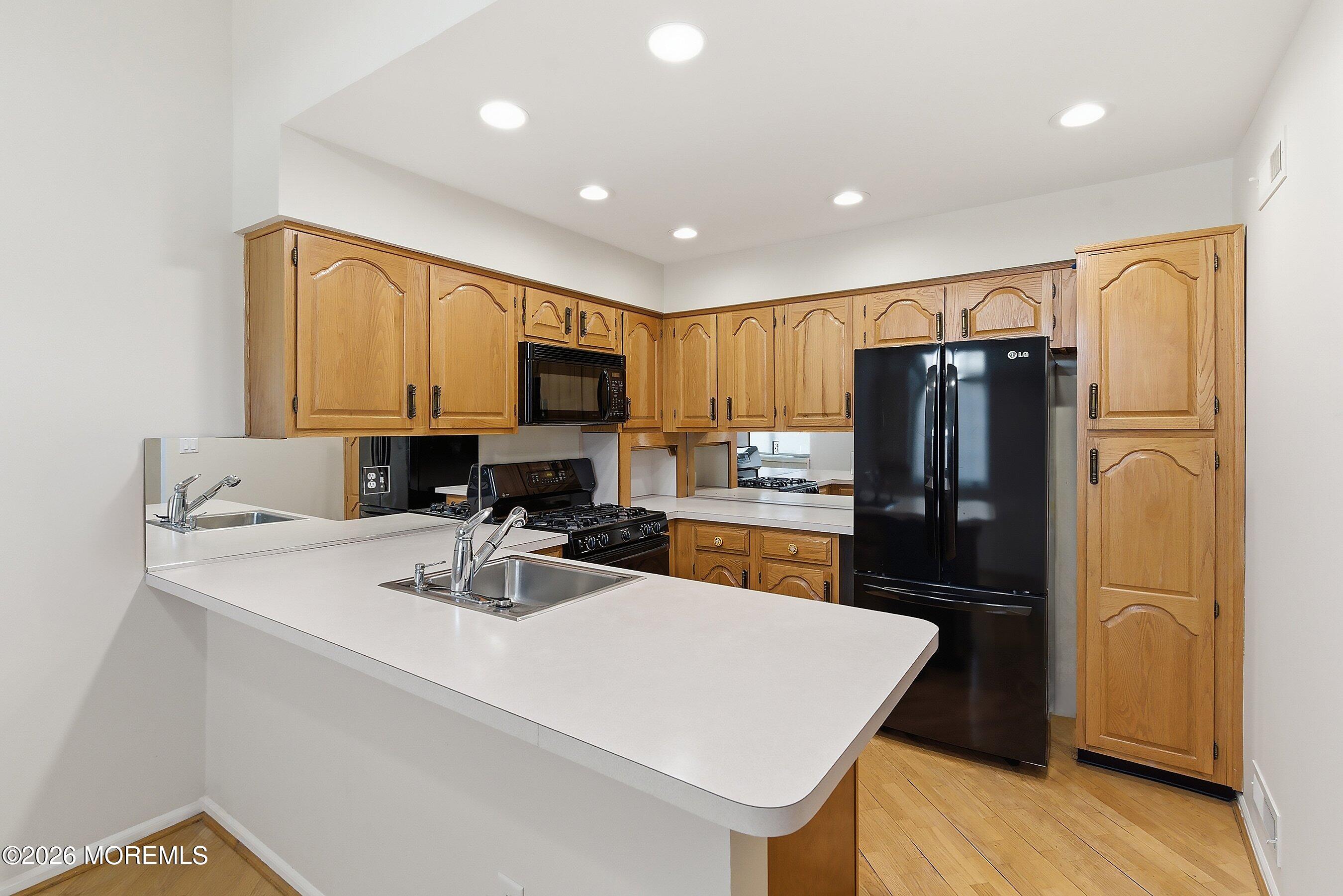 34 B Rutland Lane Monroe Township, NJ 08831 - Photo 6 of 46 a kitchen with stainless steel appliances a refrigerator sink and microwave
