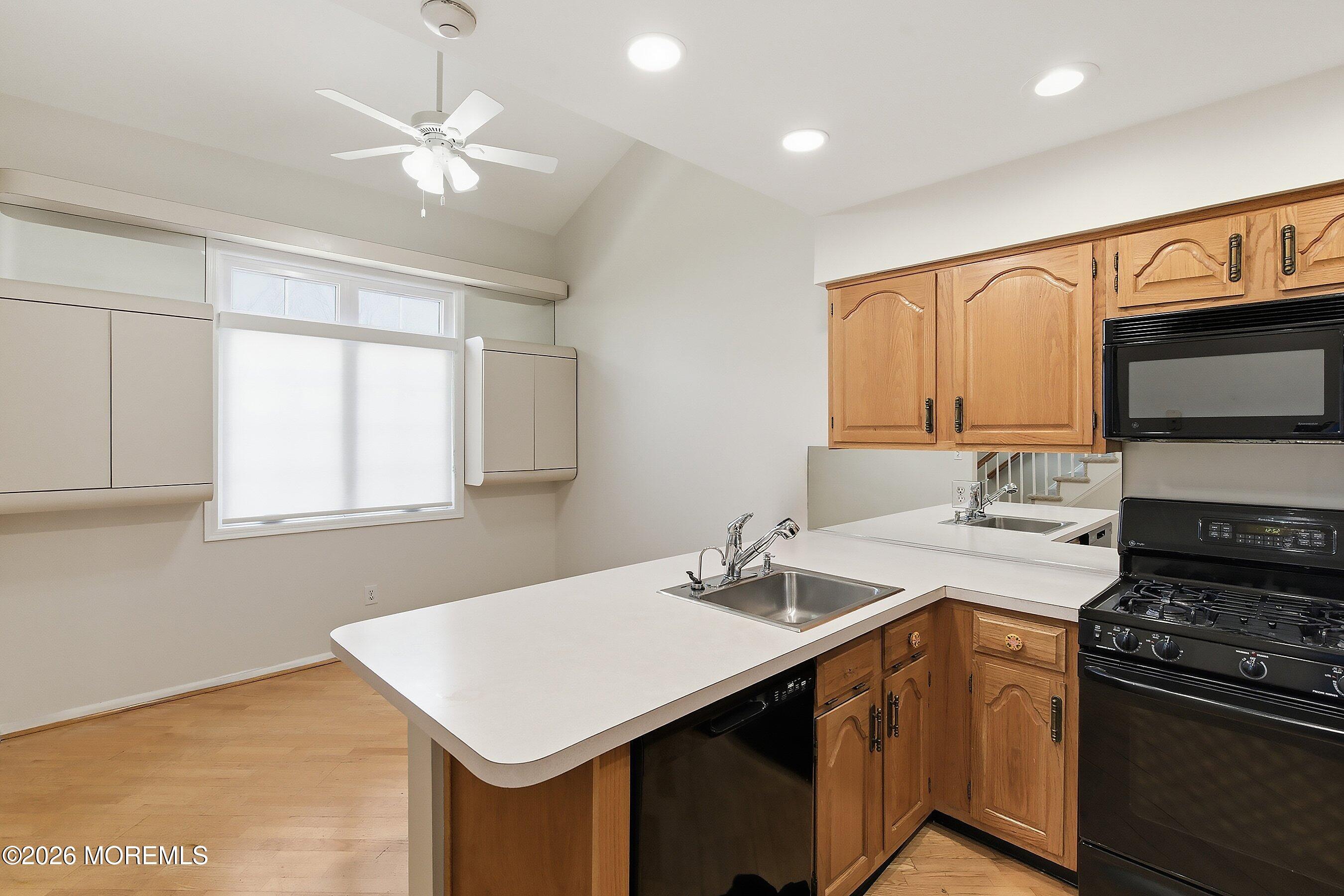 34 B Rutland Lane Monroe Township, NJ 08831 - Photo 8 of 46 a kitchen that has a sink a stove and a microwave