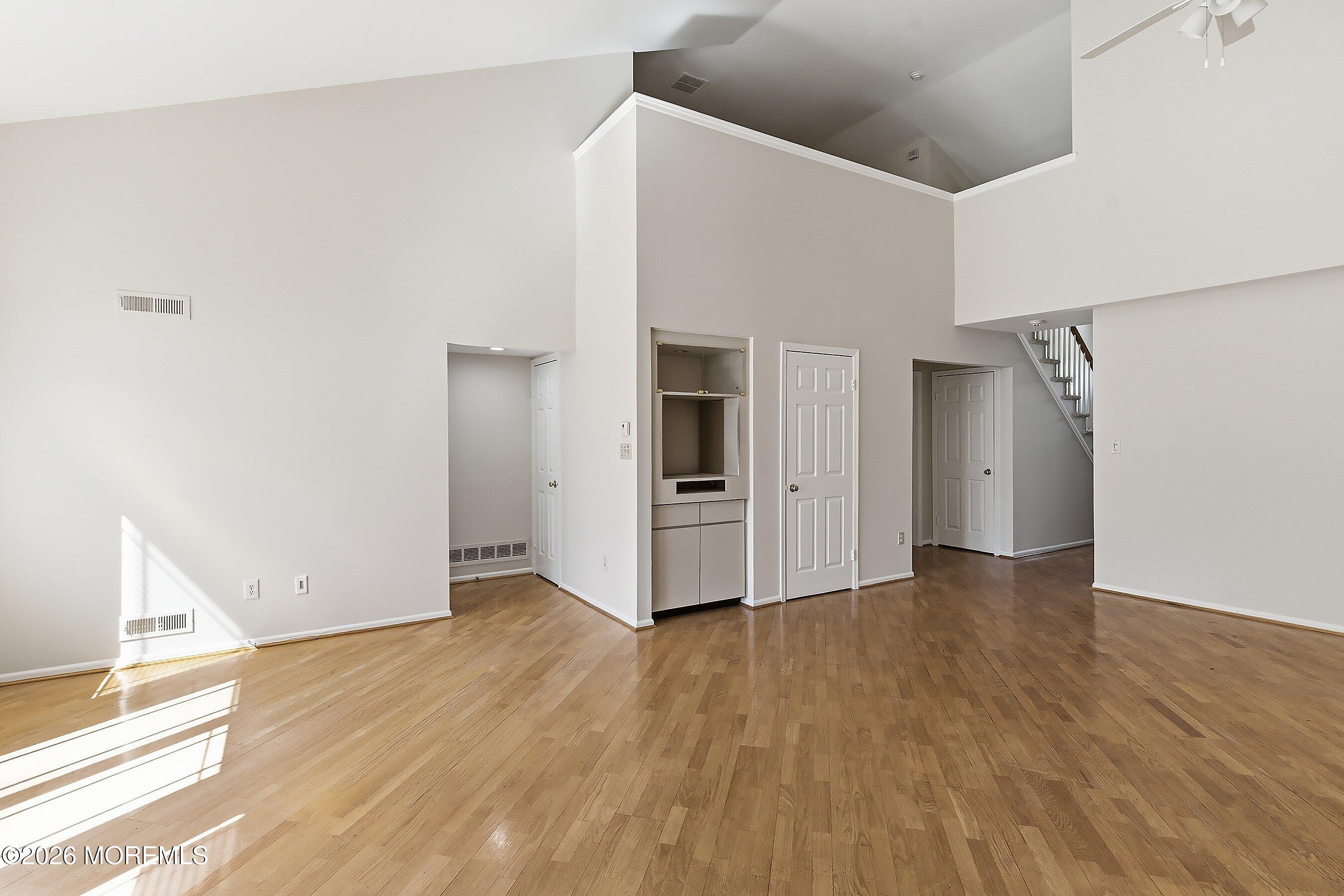34 B Rutland Lane Monroe Township, NJ 08831 - Photo 9 of 46 a view of an empty room with wooden floor and a window