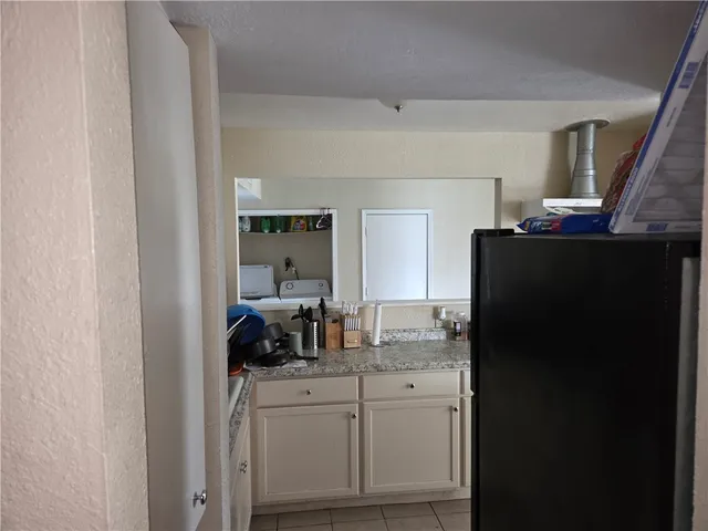 a kitchen with a refrigerator and a sink