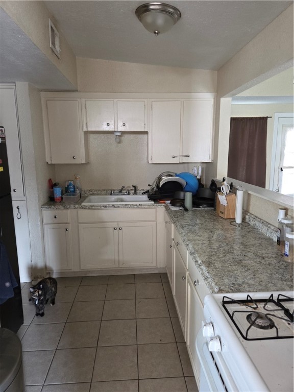 4845 Monitor Street Corpus Christi, TX 78415 - Photo 5 of 16 a kitchen with a sink stove and cabinets